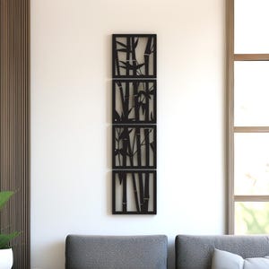 May include: A set of four black bamboo wall art panels. Each panel features a different bamboo stalk design. The panels are rectangular and arranged vertically on a white wall, creating a modern, nature-inspired decor element.