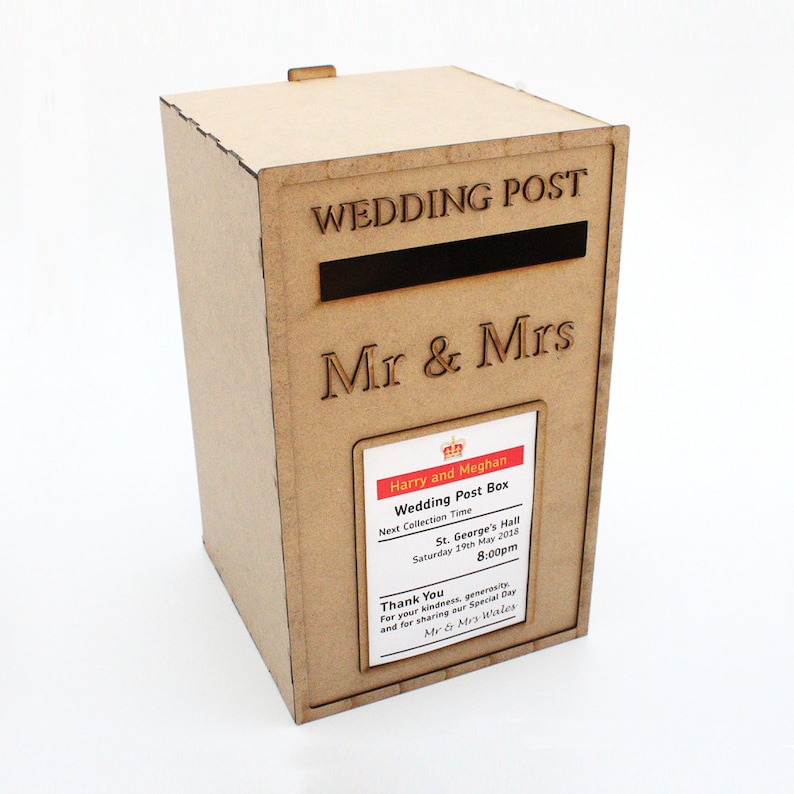 May include: A light brown wooden wedding post box with the words "WEDDING POST" and "Mr & Mrs" engraved on the front. A slot is cut into the front. A label reads "Harry and Meghan Wedding Post Box".