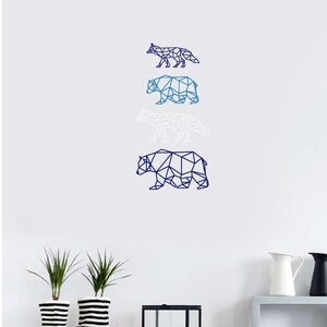 May include: A wall decal set featuring four geometric animal silhouettes arranged vertically. The designs include a dark blue fox, a medium blue bear, a white fox, and a large dark blue bear, all rendered in a clean, angular, polygon-style line art.