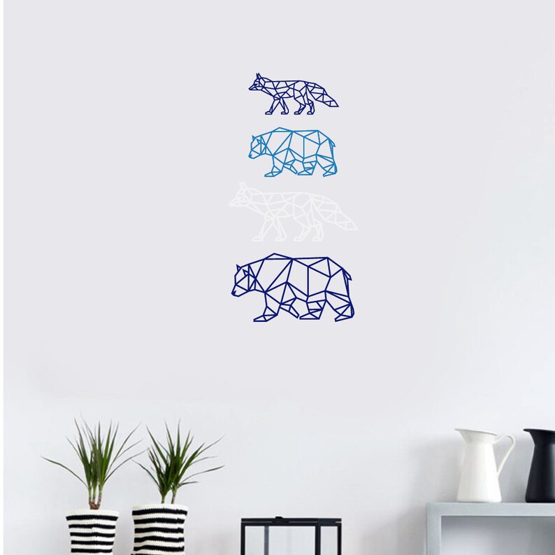 May include: A wall decal set featuring four geometric animal silhouettes arranged vertically. The designs include a dark blue fox, a medium blue bear, a white fox, and a large dark blue bear, all rendered in a clean, angular, polygon-style line art.