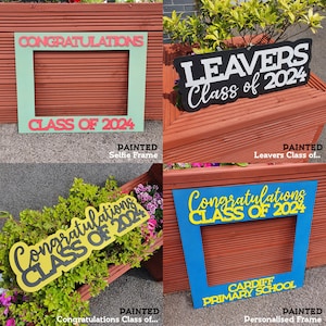 May include: Four painted graduation photo frames. One is a green frame with "CONGRATULATIONS" and "CLASS OF 2024" in red. Another is a black sign that says "LEAVERS Class of 2024". A third is a yellow sign that says "Congratulations CLASS OF 2024". The last is a blue frame with "Congratulations CLASS OF 2024" and "CARDIFF PRIMARY SCHOOL".