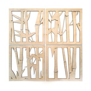 May include: Four square wooden wall art panels with a bamboo design. Each panel is a light natural wood color, with the bamboo stalks and leaves cut out, creating a negative space effect. The panels are arranged in a 2x2 grid.