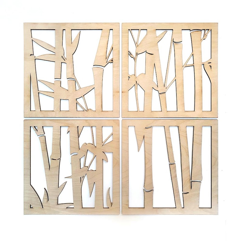 May include: Four square wooden wall art panels with a bamboo design. Each panel is a light natural wood color, with the bamboo stalks and leaves cut out, creating a negative space effect. The panels are arranged in a 2x2 grid.