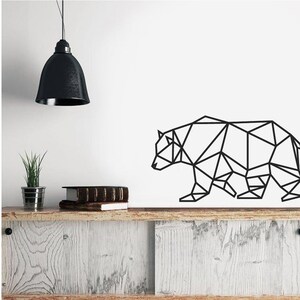 May include: A black geometric wall decal depicting the silhouette of a bear. The design is composed of interconnected straight lines and triangles, creating a stylized, angular representation of the animal in a walking profile position.