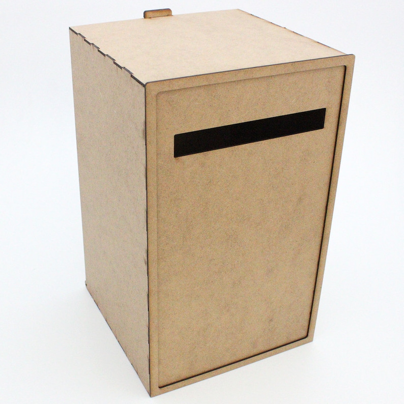 May include: A rectangular, light brown wooden mailbox with a black slot for mail. The mailbox has a small, rectangular handle on top. The design is simple and modern, with clean lines and a minimalist aesthetic.