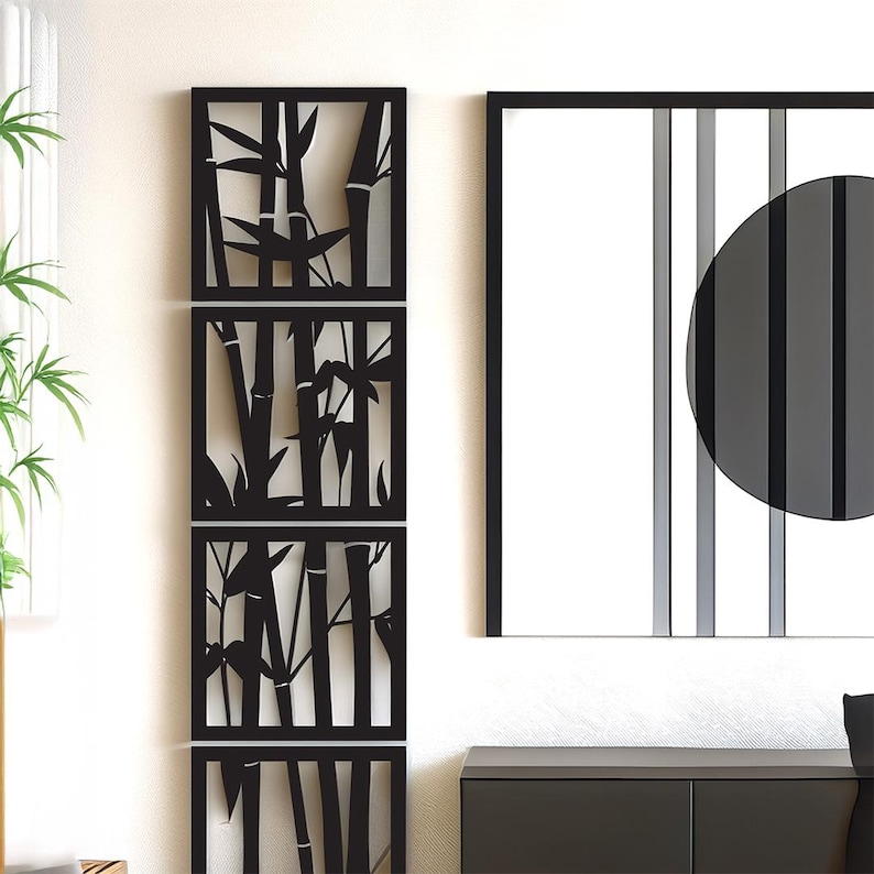 May include: Black metal wall art featuring a bamboo design. The art is composed of three rectangular panels stacked vertically, each with a cut-out bamboo silhouette. A framed artwork with a black circle and vertical stripes is also visible.