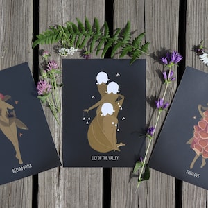 May include: Three black and gold prints with illustrations of women made of flowers. The prints are titled "Belladonna", "Lily of the Valley", and "Foxglove".