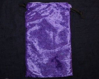 May include: A deep purple velvet drawstring bag. The bag is rectangular with a gathered top and a black drawstring. The velvet has a textured appearance. The website address www.WitchcraftEmporium.co.uk is visible at the bottom.