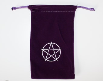 May include: A purple velvet pouch with a white pentagram embroidered on the front. The pouch has a drawstring closure and is perfect for storing small items.