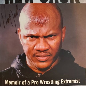 May include: A book cover with a black and white photo of a man with a shaved head. The title of the book is "NEW JACK" and the subtitle is "Memoir of a Pro Wrestling Extremist". The book is written by "NEW JACK and JASON NORMAN" with a foreword by "BRIAN HEFFRON, aka the BLUE MEANIE".
