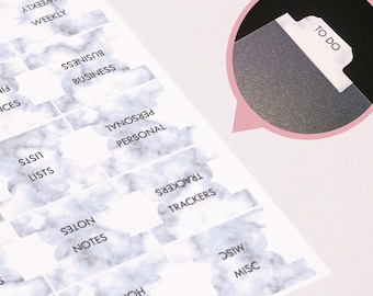 May include: A set of 16 marble-patterned divider tabs with different categories written on them, including "To Do", "Daily", "Weekly", "Business", "Finances", "Projects", "Contacts", "Lists", "Personal", "Trackers", "Notes", "Travels", "Shopping", "Home", and "Misc".
