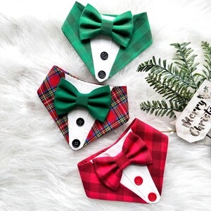 May include: Three dog collars with bow ties. One collar is green and white checked with a green bow tie. One collar is red and white checked with a green bow tie. One collar is red and white checked with a red bow tie.