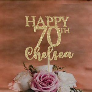 May include: Gold glitter cake topper with the text "Happy 70th Chelsea".
