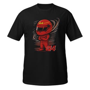 Black tee flat-lay with the red chibi racer graphic and "Lewis Hamilton" text, front view with visible fabric texture.