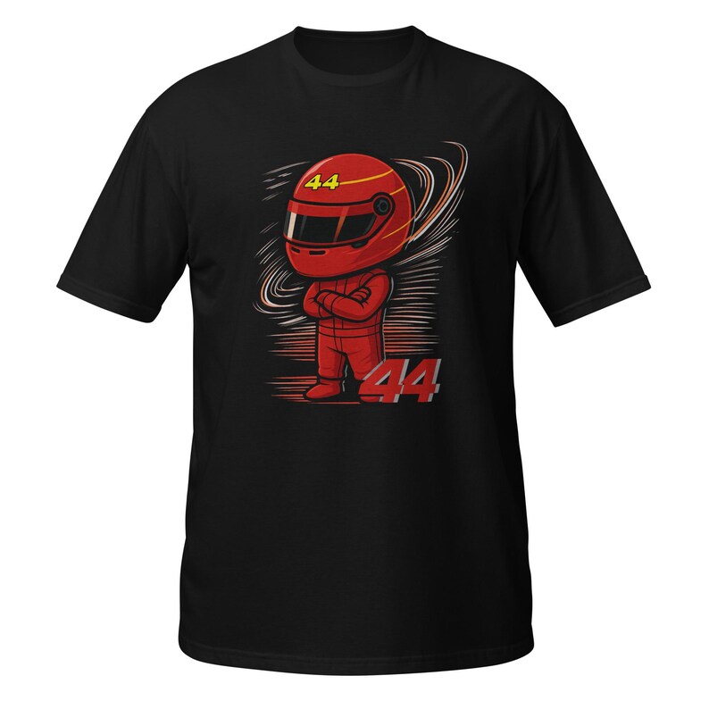 Black tee flat-lay with the red chibi racer graphic and "Lewis Hamilton" text, front view with visible fabric texture.