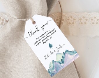 May include: White thank you tag with a watercolor illustration of mountains and a pine tree. The text reads "Thank you for your continuous love and support and for sharing this special day with us!" and "Belinda & Jackson".