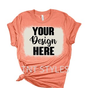 May include: A coral coloured t-shirt with a white bleached design that says "YOUR Design HERE" and "TNT STYLES" at the bottom.