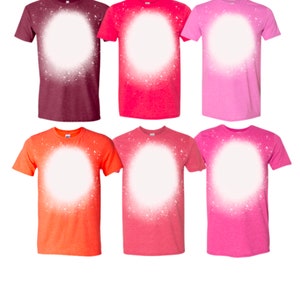 May include: Six t-shirts in various colors with a white bleach-splattered design in the center of each shirt. The shirts are maroon, red, pink, orange, coral, and light pink.