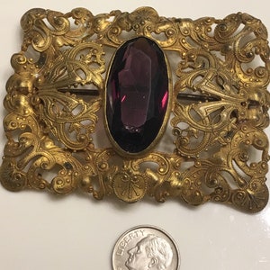Art nouveau ornate brass brooch or belt buckle with a chipped amethyst glass in the middle circa 1900s image 2