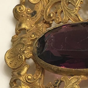 Art nouveau ornate brass brooch or belt buckle with a chipped amethyst glass in the middle circa 1900s image 6