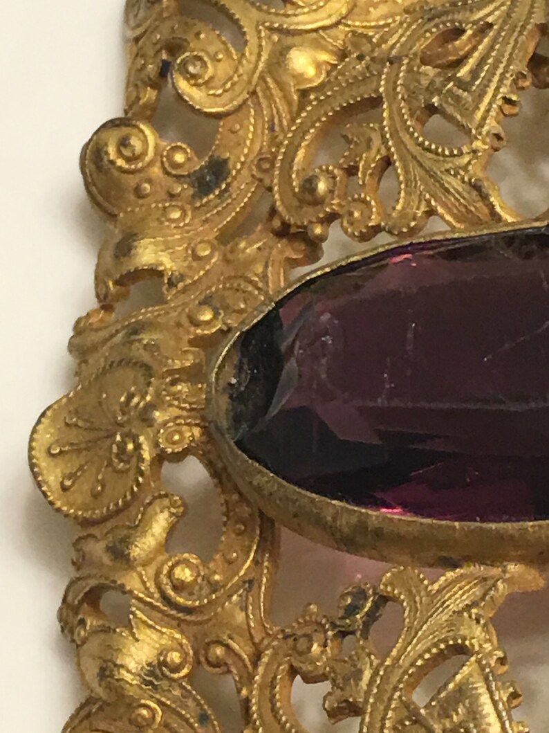 Art nouveau ornate brass brooch or belt buckle with a chipped amethyst glass in the middle circa 1900s image 6