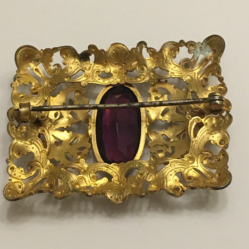 Art nouveau ornate brass brooch or belt buckle with a chipped amethyst glass in the middle circa 1900s image 3