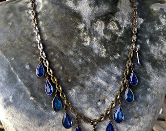 Antique Art Deco 16 inch bib choker necklace in graduated tear drop blue lagoon glass in silverplate chain. Circa 1920’s