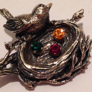 Vintage Sterling silver Bird and nest Brooch by Anson's with Emerald Ruby Topaz color gem. Brooch in perfect condition.