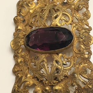 Art nouveau ornate brass brooch or belt buckle with a chipped amethyst glass in the middle circa 1900s image 4