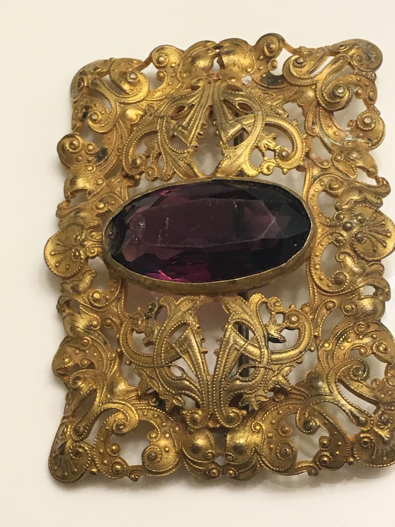 Art nouveau ornate brass brooch or belt buckle with a chipped amethyst glass in the middle circa 1900s image 4