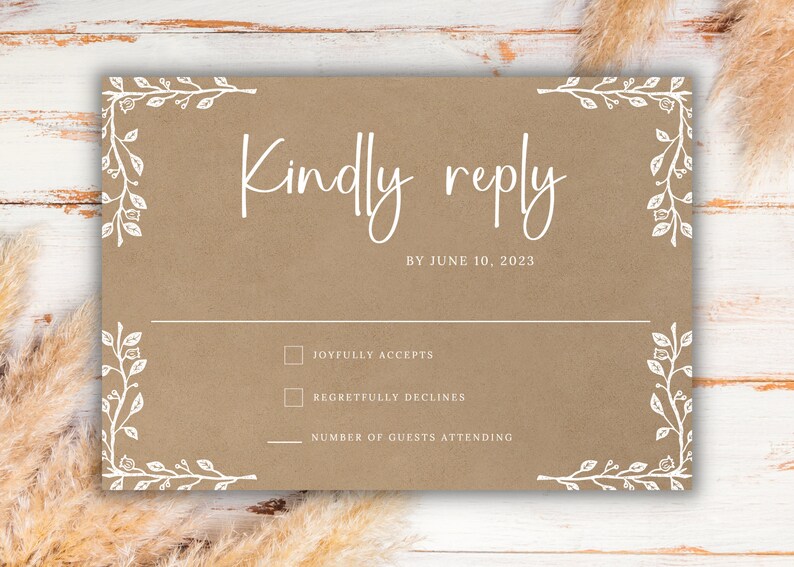 May include: A tan wedding RSVP card with white text and floral corner accents. The card reads "Kindly reply by June 10, 2023." Includes checkboxes for accepting or declining, and a line for the number of guests attending.