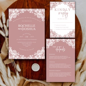 May include: A blush pink wedding invitation suite with white lace detailing. The invitation features the names Rochelle and Joshua, the date May 20, 2025, and the location Gleneagles Country Club. The RSVP card includes the text "Kindly reply by April 29, 2025". The details card includes information about the wedding, lodging, and website.