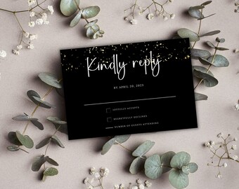 May include: Black RSVP card with gold glitter accents. The text reads "Kindly reply by April 20, 2023". There are checkboxes for "Joyfully accepts" and "Regretfully declines".