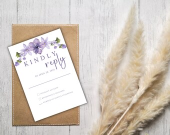 May include: A white RSVP card with a purple floral border. The text reads "KINDLY reply BY APRIL 20, 2025". There are three checkboxes with the following text: "Joyfully Accepts", "Regretfully Declines", and "Number of Guests Attending".