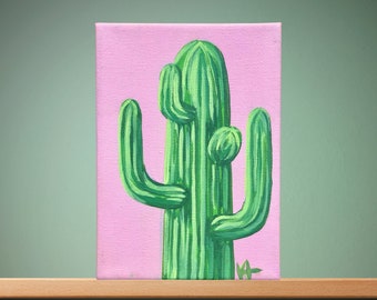 May include: A painting of a green cactus with a pink background. The cactus has multiple arms and is depicted in a stylized manner.