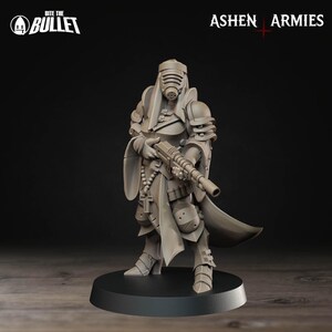 May include: A detailed figurine of a warrior in futuristic armour, holding a rifle. The figure is in a neutral colour, with a helmet and a long coat. The base is black, and the background is dark. The text "Bite the Bullet" and "Ashen Armies" are visible.