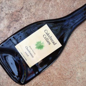 May include: A dark glass wine bottle with a white label that reads "Cakebread Cellars" and "Napa Valley Chardonnay 2008".