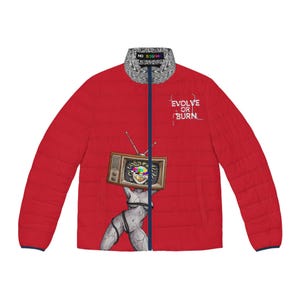 May include: A red puffer jacket with a dark blue zip and a grey patterned collar featuring the text NO SIGNAL. The front displays a graphic of a stone-like figure holding a television set with a colour bar screen and the text EVOLVE OR BURN.