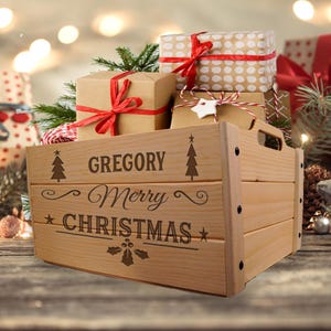 May include: A wooden crate with the name "GREGORY" and the words "Merry CHRISTMAS" engraved on the front. The crate is filled with wrapped gifts tied with red ribbons. The gifts are in various sizes and patterns, with a festive holiday theme.