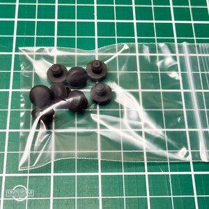 May include: A clear plastic bag containing a set of ten black rubber bumpers.