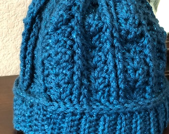 Gorro de ganchillo trenzado de color verde azulado iridiscente, talla infantil, hecho a mano.