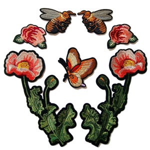 May include: Embroidered patches featuring floral and insect designs. The collection includes two bees, two roses, a butterfly, and two poppy flowers with green leaves. The patches have detailed stitching and a black border, perfect for adding to clothing or accessories.