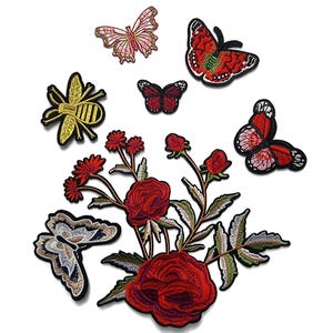 May include: Assortment of embroidered iron-on patches featuring butterflies, bees, and roses. The patches are in shades of red, pink, yellow, and green.