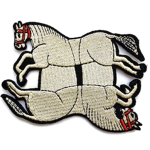 May include: Embroidered patch featuring two beige horses in a mirrored, overlapping design. The horses are facing opposite directions, with their heads and tails touching. The horses have black outlines and red bridles.