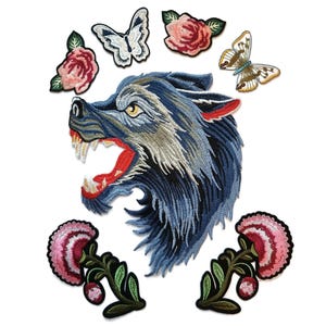 May include: Embroidered iron-on patches featuring a blue wolf head, pink and red roses, and white butterflies.