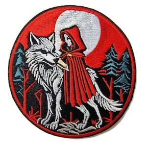 May include: Embroidered patch featuring a white wolf and a girl in a red hooded cloak standing in a forest under a full moon. The patch is circular and has a black background with red and blue accents.