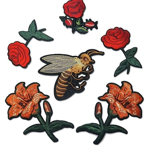 May include: Embroidered patches featuring a bee, red roses, and orange lilies. The patches have detailed stitching and are set against a white background. These patches are ideal for adding a decorative touch to clothing or accessories.