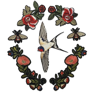 May include: A collection of embroidered patches featuring a central swallow in flight, flanked by two bees, two upper floral sprays with red blossoms, and two lower curved vine motifs with orange flowers and green leaves on a white background.