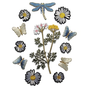May include: A set of iron-on patches featuring a variety of designs, including butterflies, daisies, and a sprig of chamomile flowers. The patches are all in shades of blue, white, and yellow.