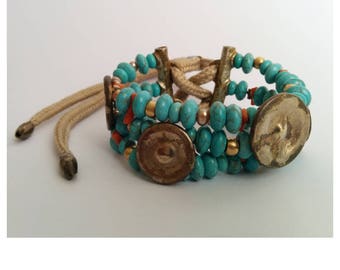 Multistrand bracelet : Oxidized brass studs, 18k solid yellow gold beads, Turquoise paste, natural Coral, Freshwater Pearls. Unique piece